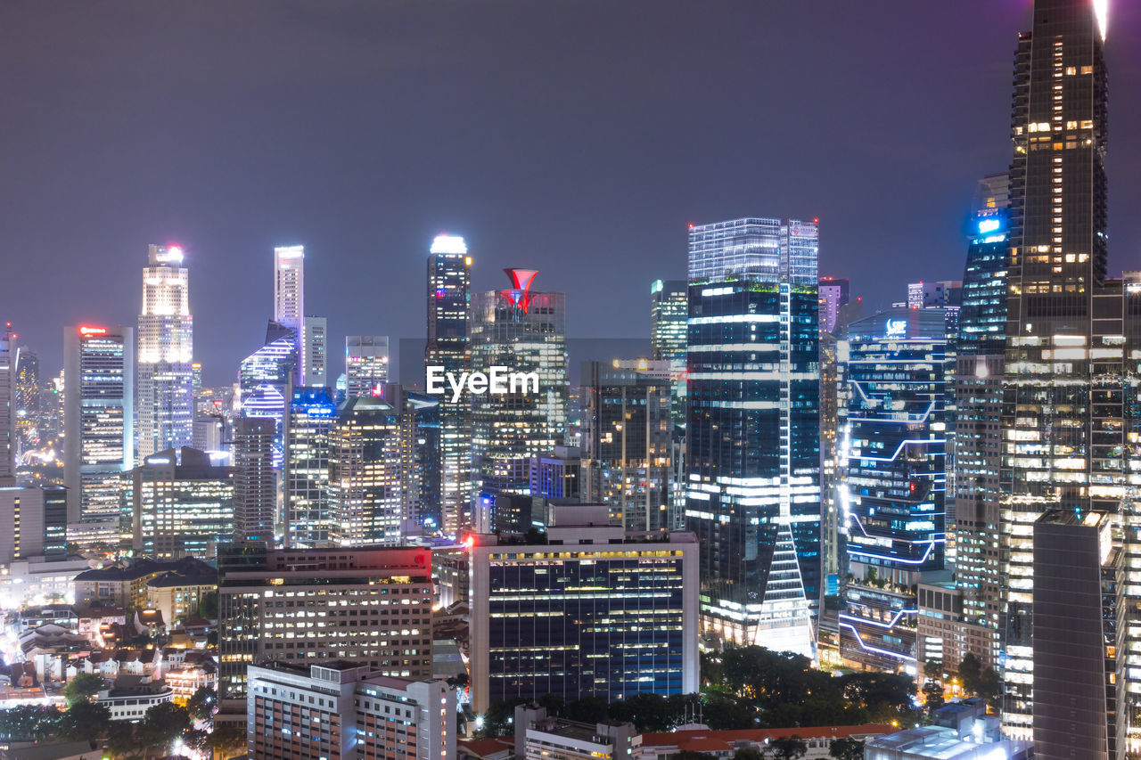 ILLUMINATED BUILDINGS AGAINST SKY AT NIGHT