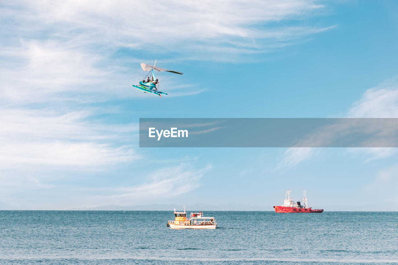 Side view of the sea with pleasure ships and a flying paraglider. fun entertainment at the seaside