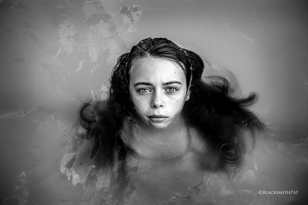 black and white, portrait, one person, black, white, darkness, monochrome photography, monochrome, looking at camera, women, long hair, adult, hairstyle, headshot, young adult, indoors, front view, human face, water, portrait photography, female, studio shot, fantasy, person, emotion, serious, digital composite, nature, spooky, wet, mystery