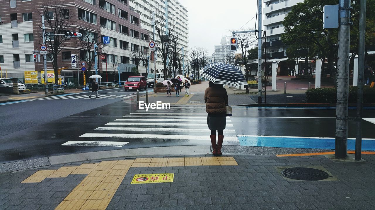 PEOPLE WALKING ON CITY STREET