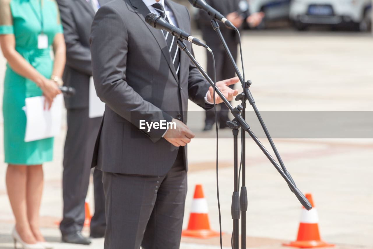 Midsection of speaker giving speech