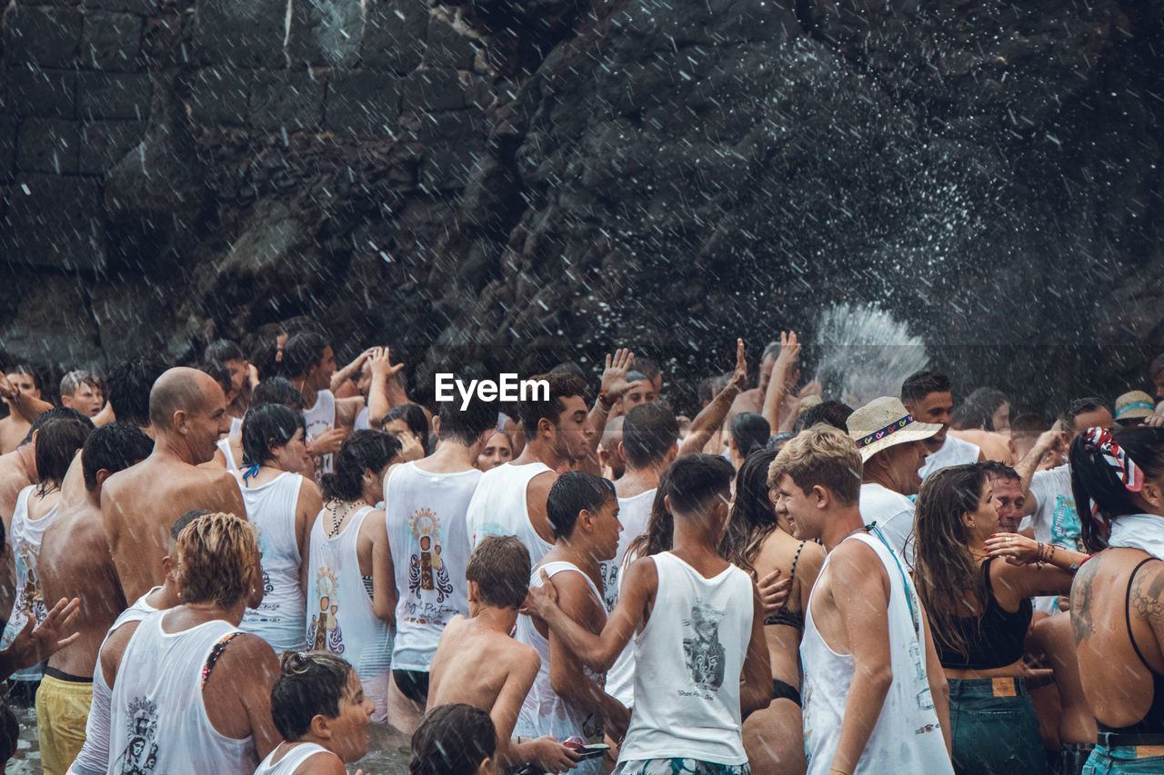 GROUP OF PEOPLE ENJOYING IN WATER AT PARK