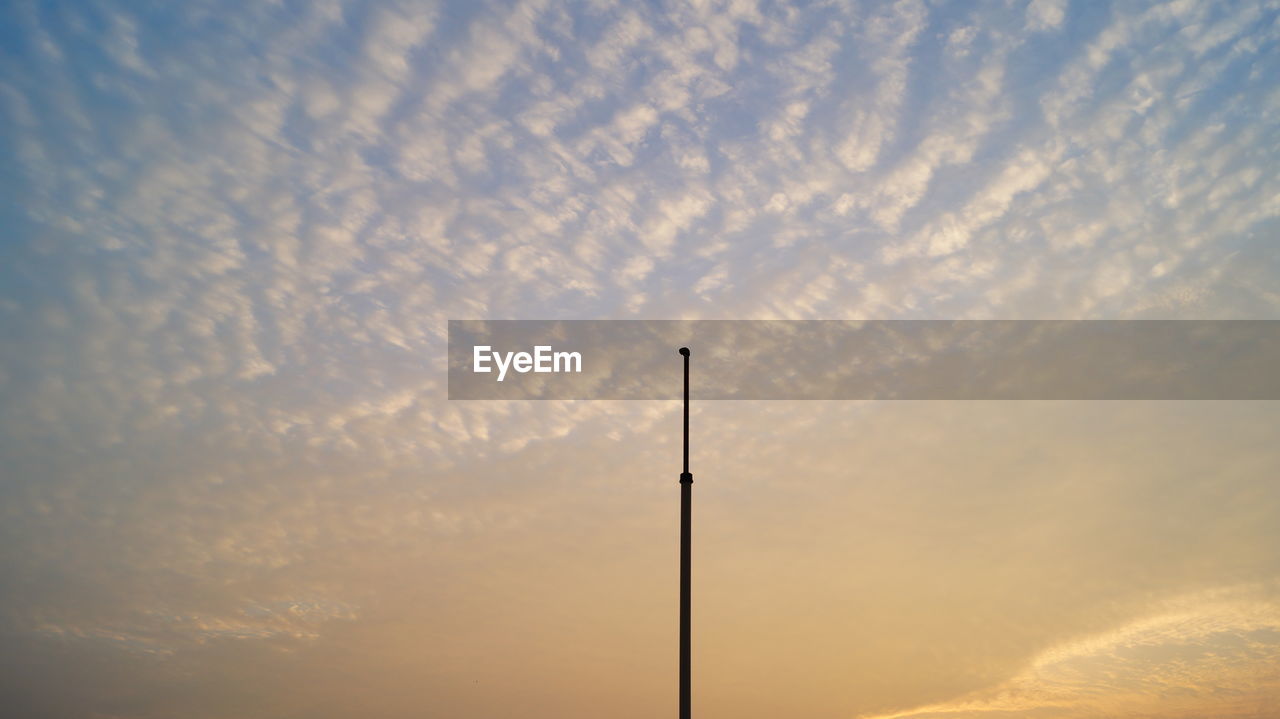 Low angle view of pole against sky during sunset