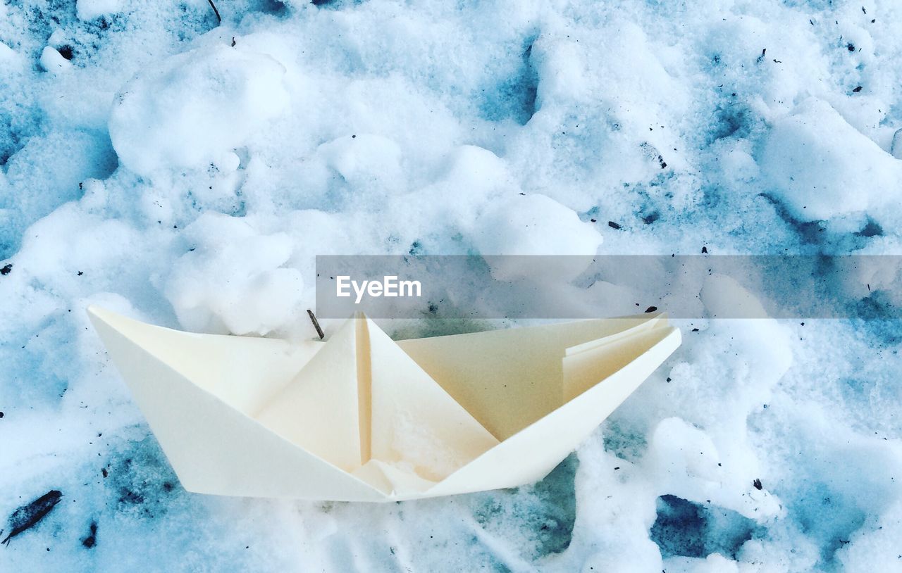 Close-up of paper boat on snow