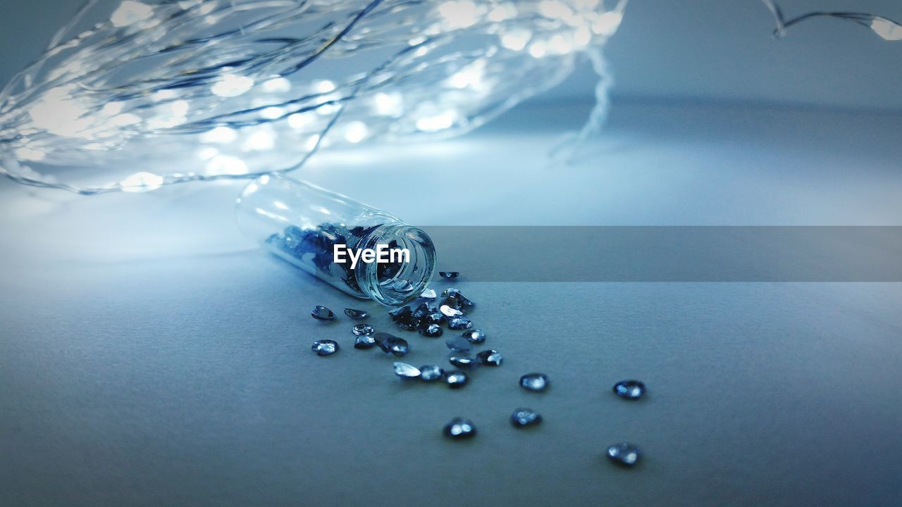 Close-up of gemstones with illuminated string lights on table