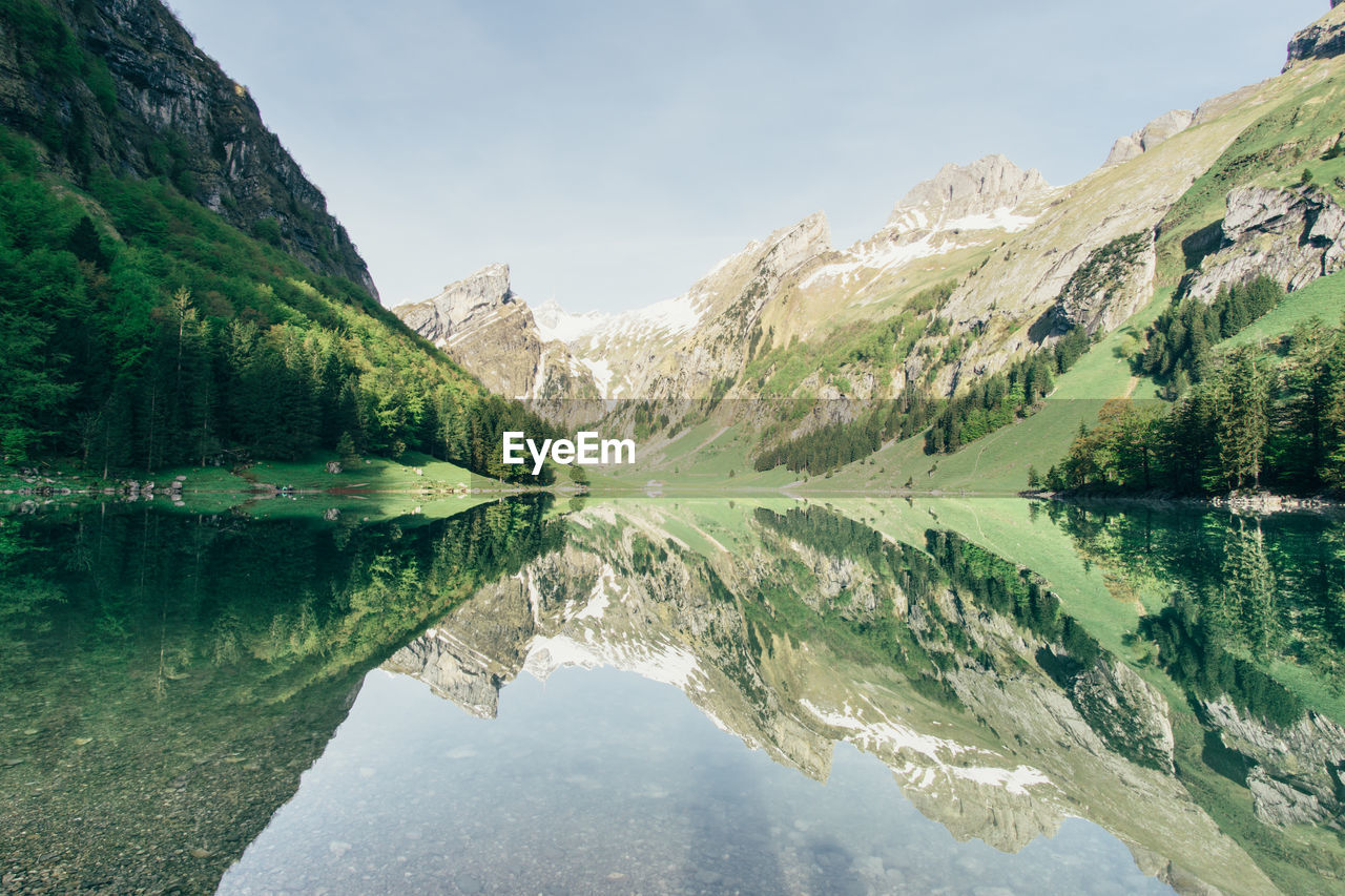 Scenic view of lake with mountains in background