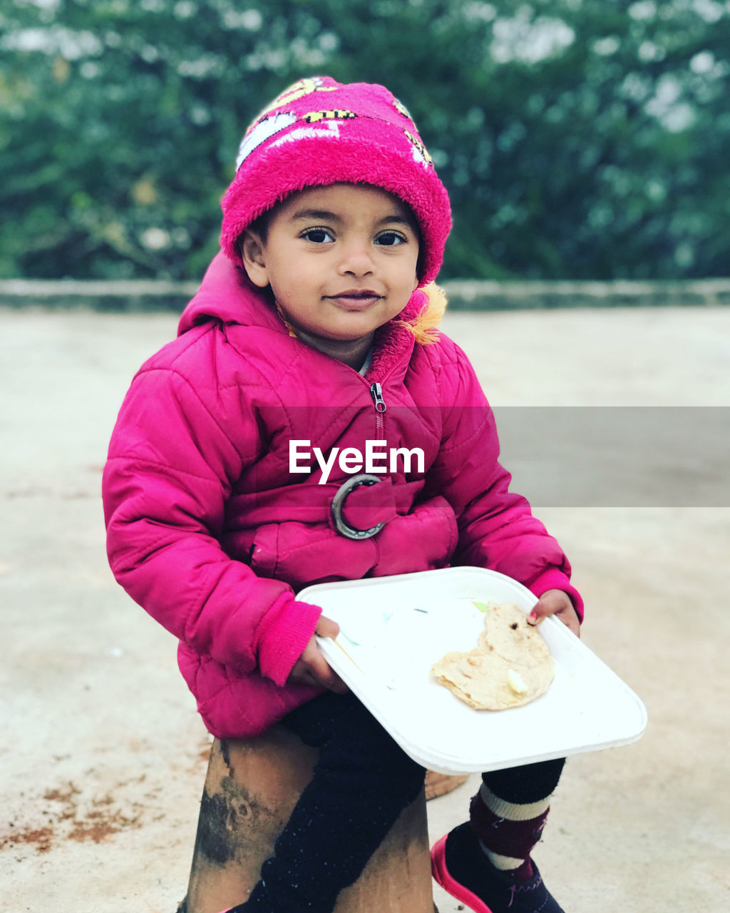 child, childhood, one person, toddler, clothing, portrait, female, food and drink, pink, cute, food, women, looking at camera, spring, hat, person, innocence, day, full length, winter, cap, nature, leisure activity, holding, sweet food, front view, lifestyles, eating, smiling, cold temperature, outdoors, warm clothing, footwear, happiness, emotion, baby, casual clothing, focus on foreground, knit hat, sweet