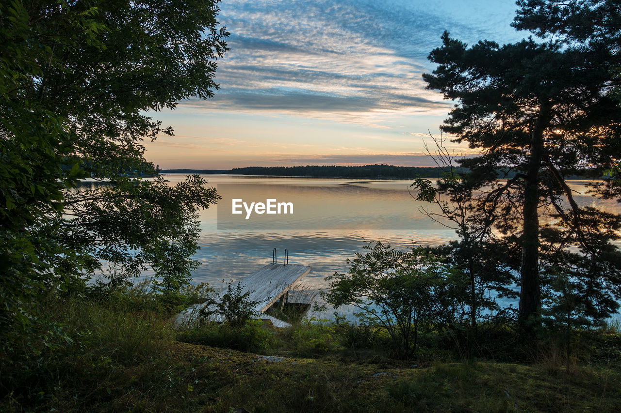 SCENIC VIEW OF LAKE AT SUNSET