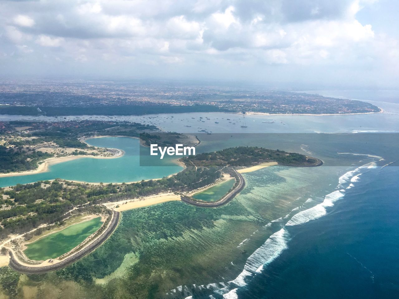 Aerial view of beach against cloudy sky