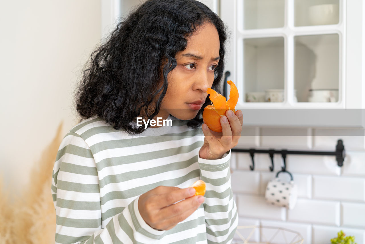 African-american female having post-covid syndrome. concept of loosing smell due to covid-19 virus