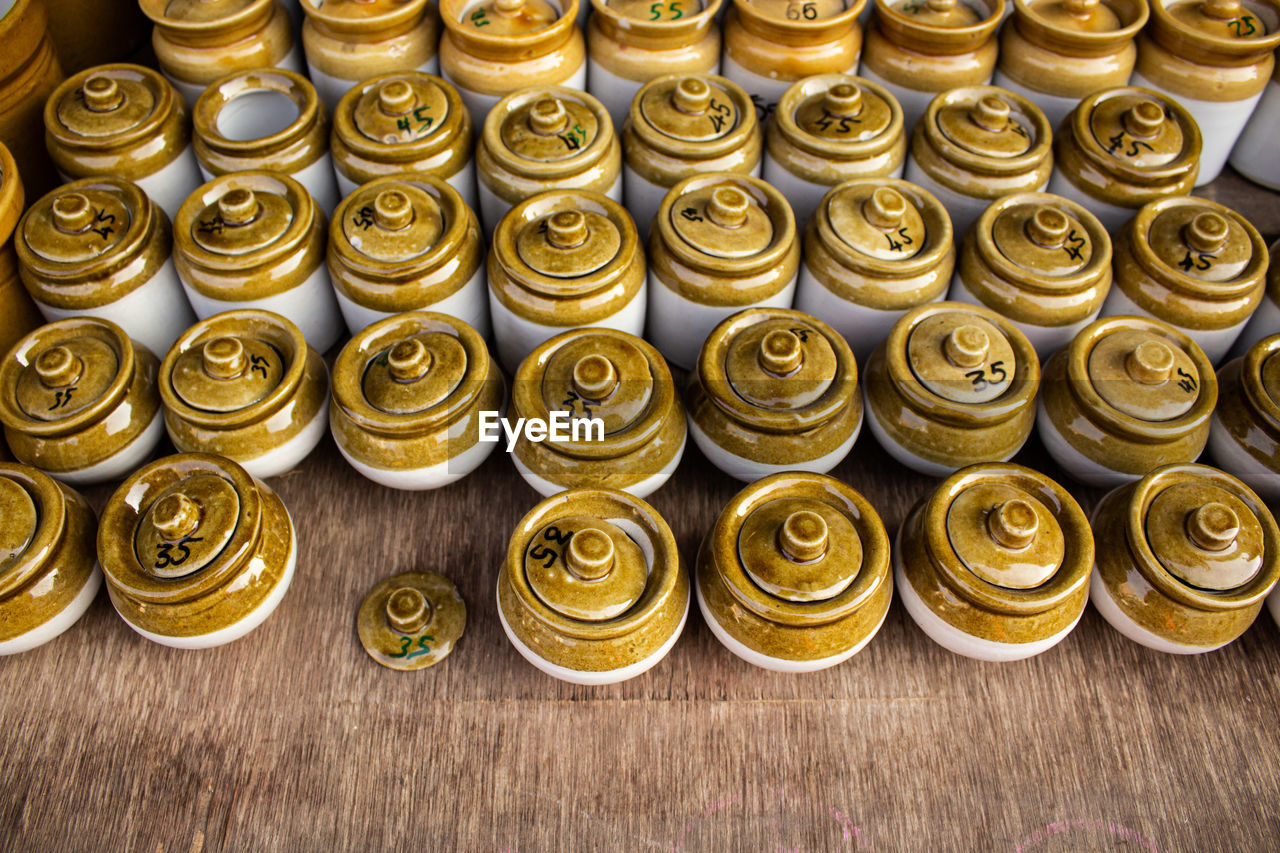 High angle view of ceramic china pots placed on a wooden table in a street shop in india