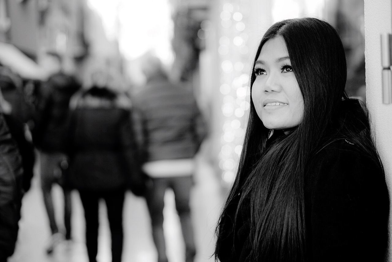 Smiling young woman looking away