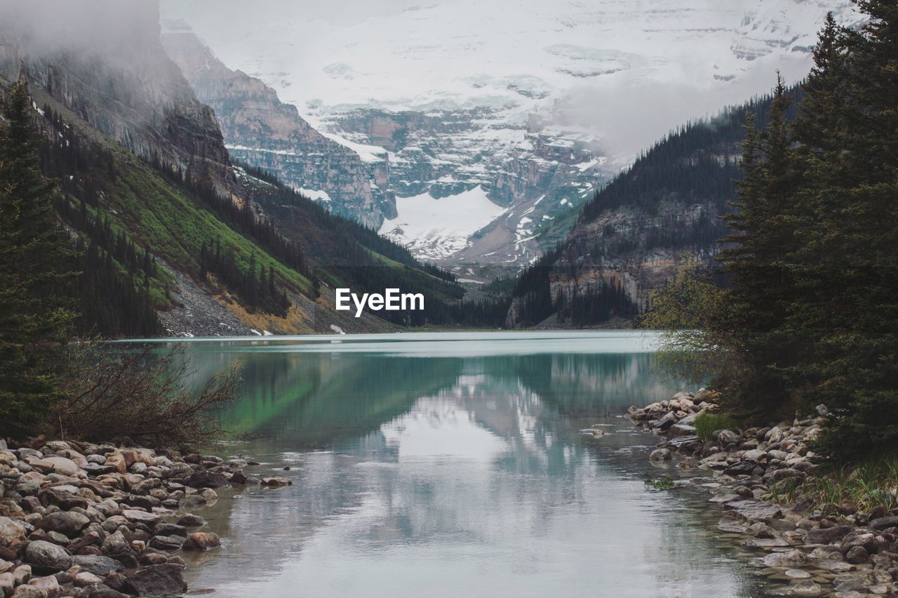 Scenic view of lake and mountains against sky