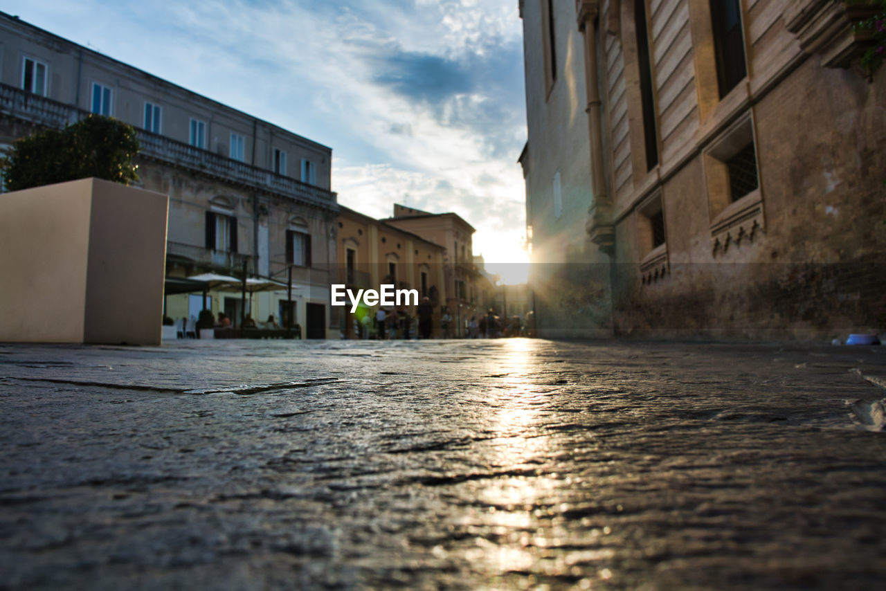 Surface level of street by buildings against sky