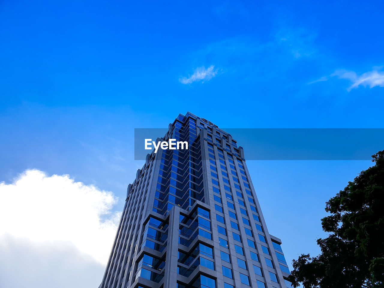 Low angle view of modern building against blue sky