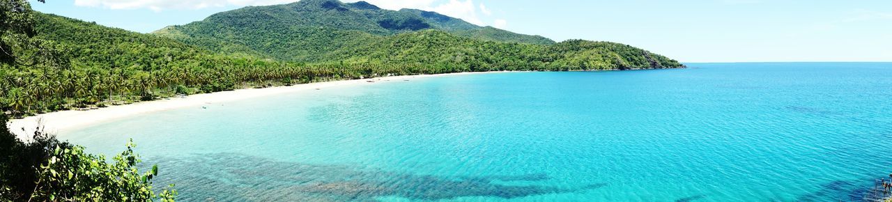 High angle view of sea and mountains against sky
