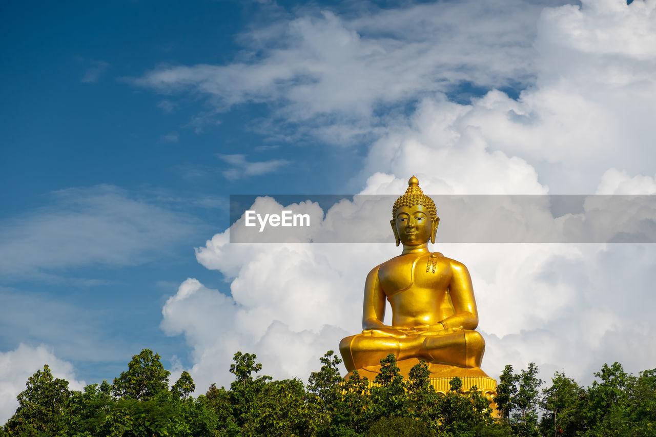 LOW ANGLE VIEW OF STATUE OF BUDDHA AGAINST SKY