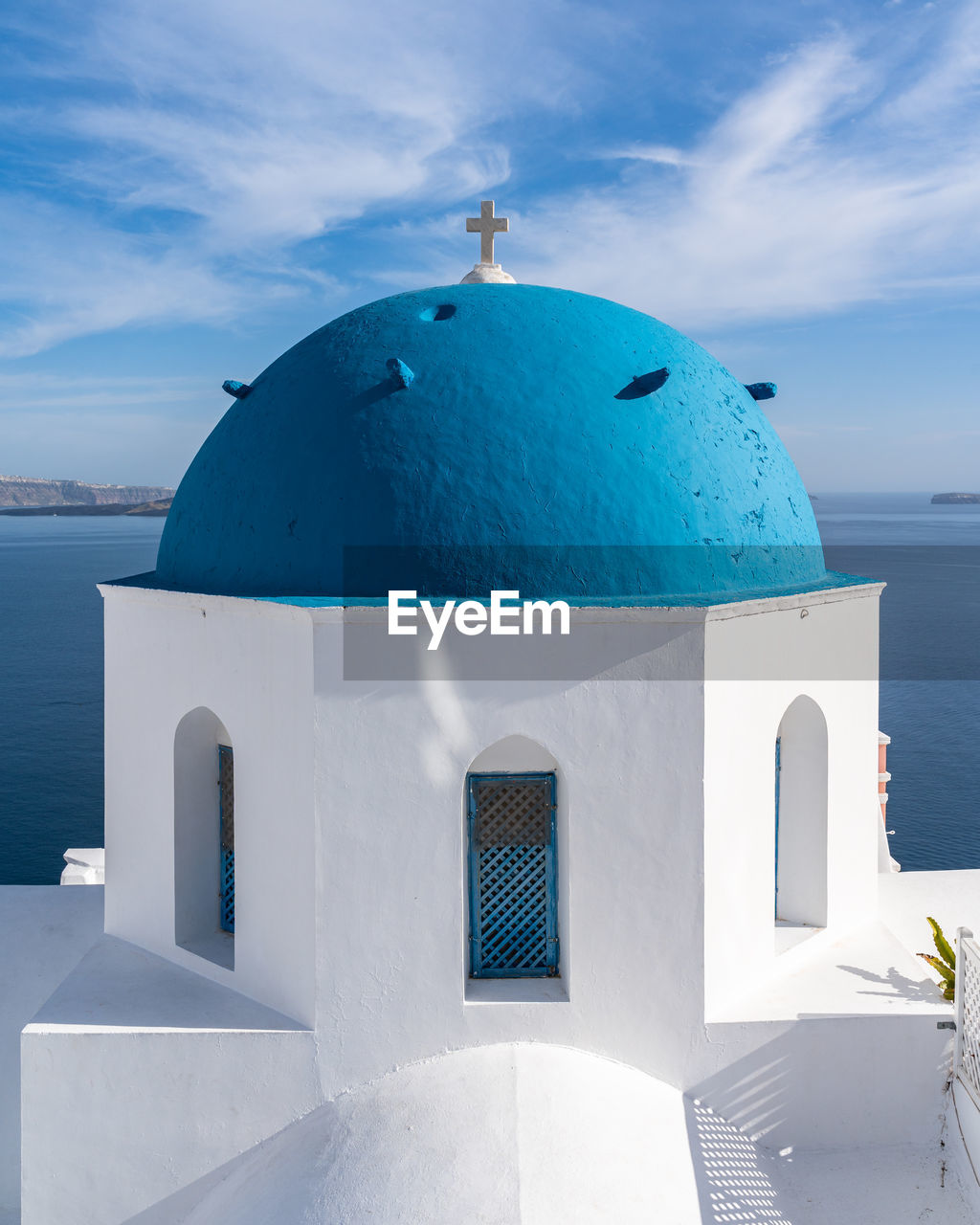 Close up of a typical blue dome church in santorini at oia village, greece