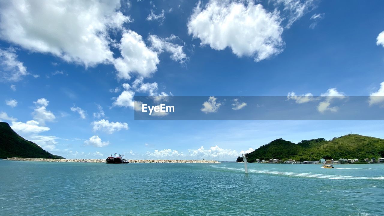 PANORAMIC VIEW OF SEA AGAINST BLUE SKY