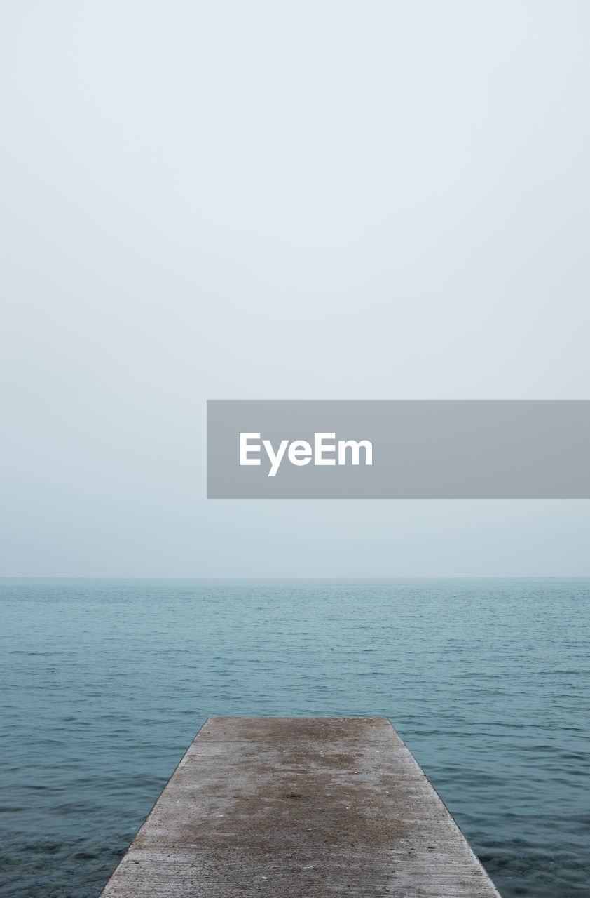 High angle view of jetty over sea against clear sky