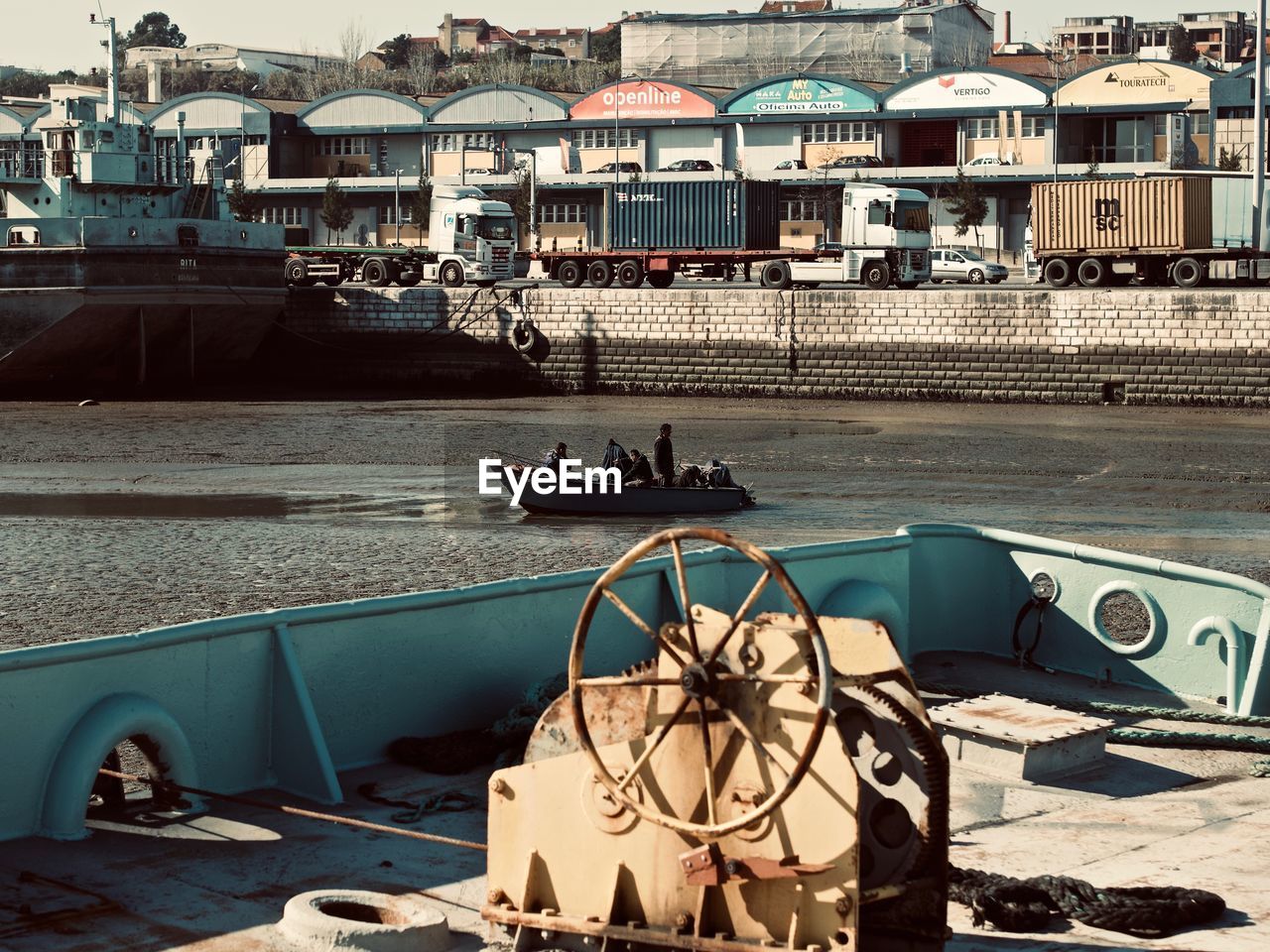 PEOPLE ON BOAT IN CITY