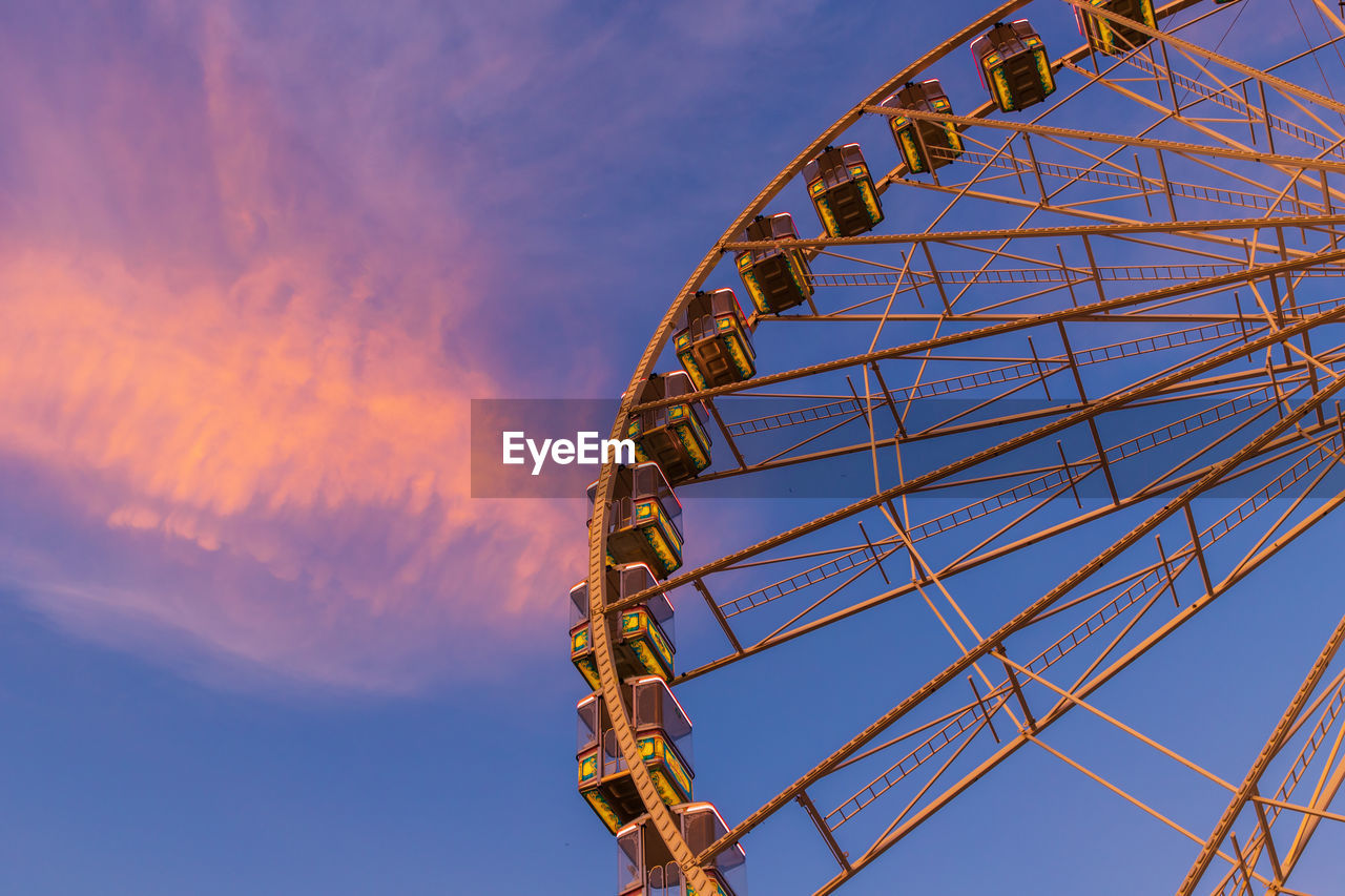 Part of a ferris wheel in sunset