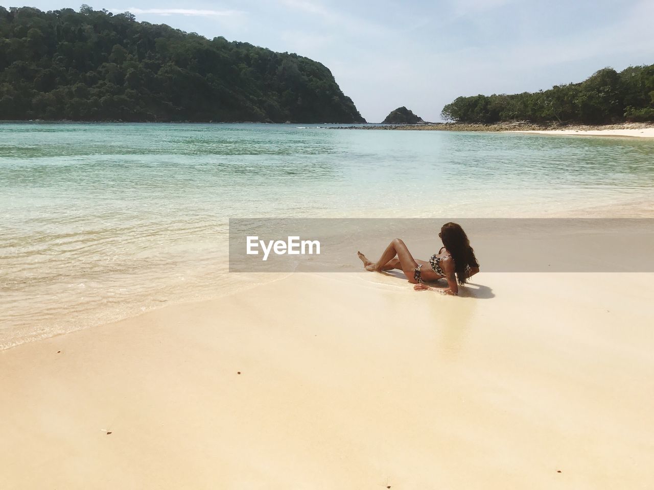 Woman in bikini sunbathing at beach