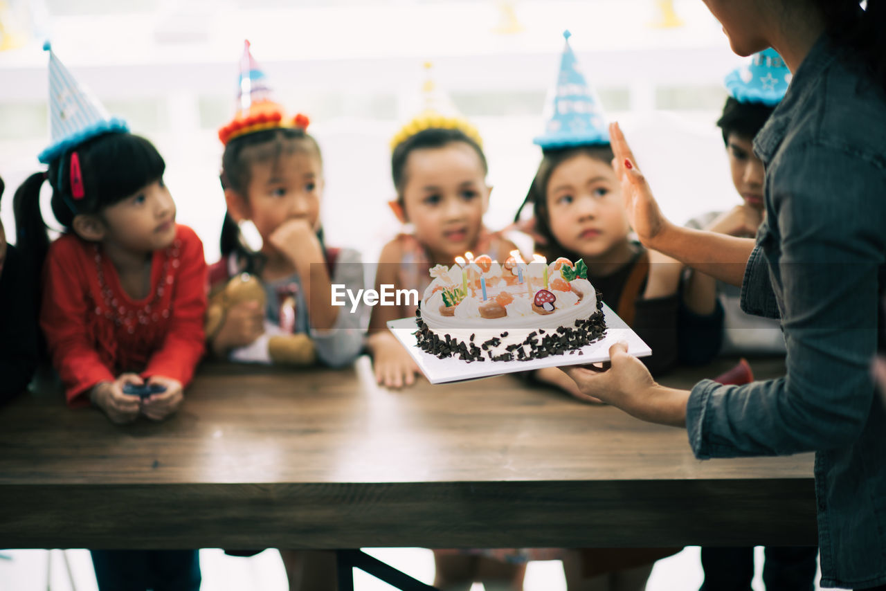 Cute happy friends enjoying birthday party at home