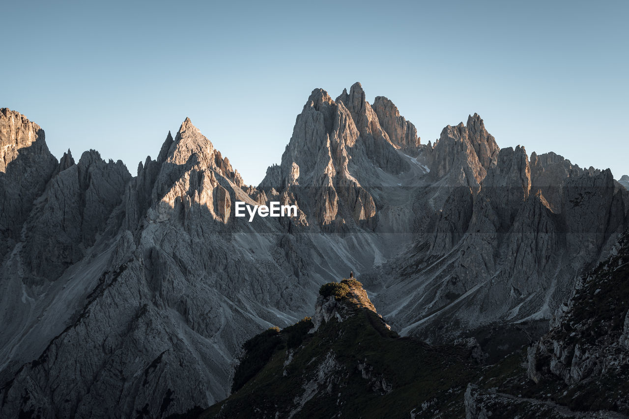 Panoramic view of rocky mountains against clear sky