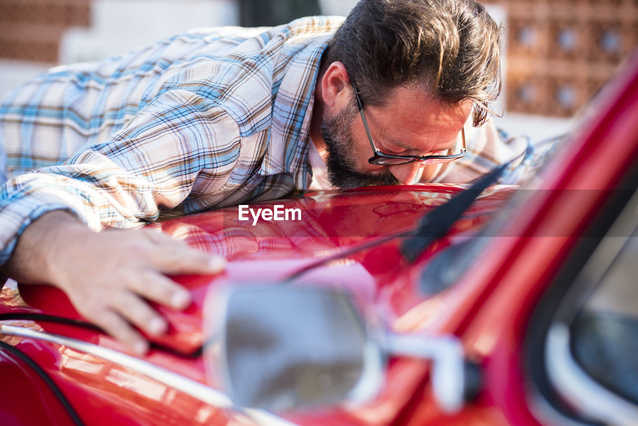 Man kissing car in showroom