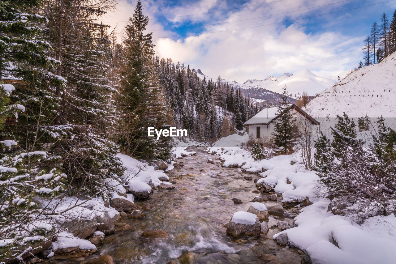 River amidst snowcapped mountains against sky