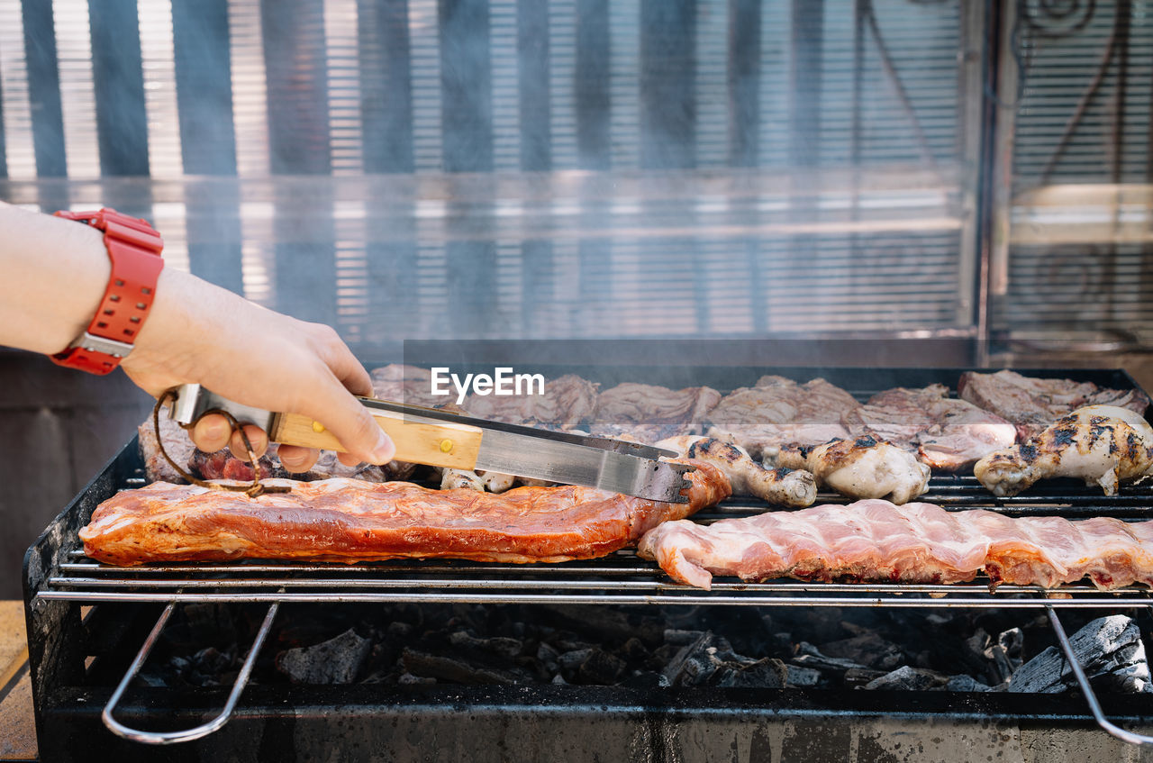 Man preparing food on barbecue grill