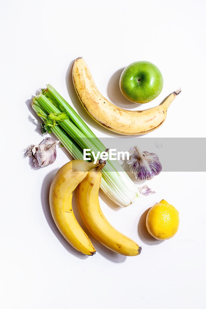 HIGH ANGLE VIEW OF FRUITS ON WHITE SURFACE