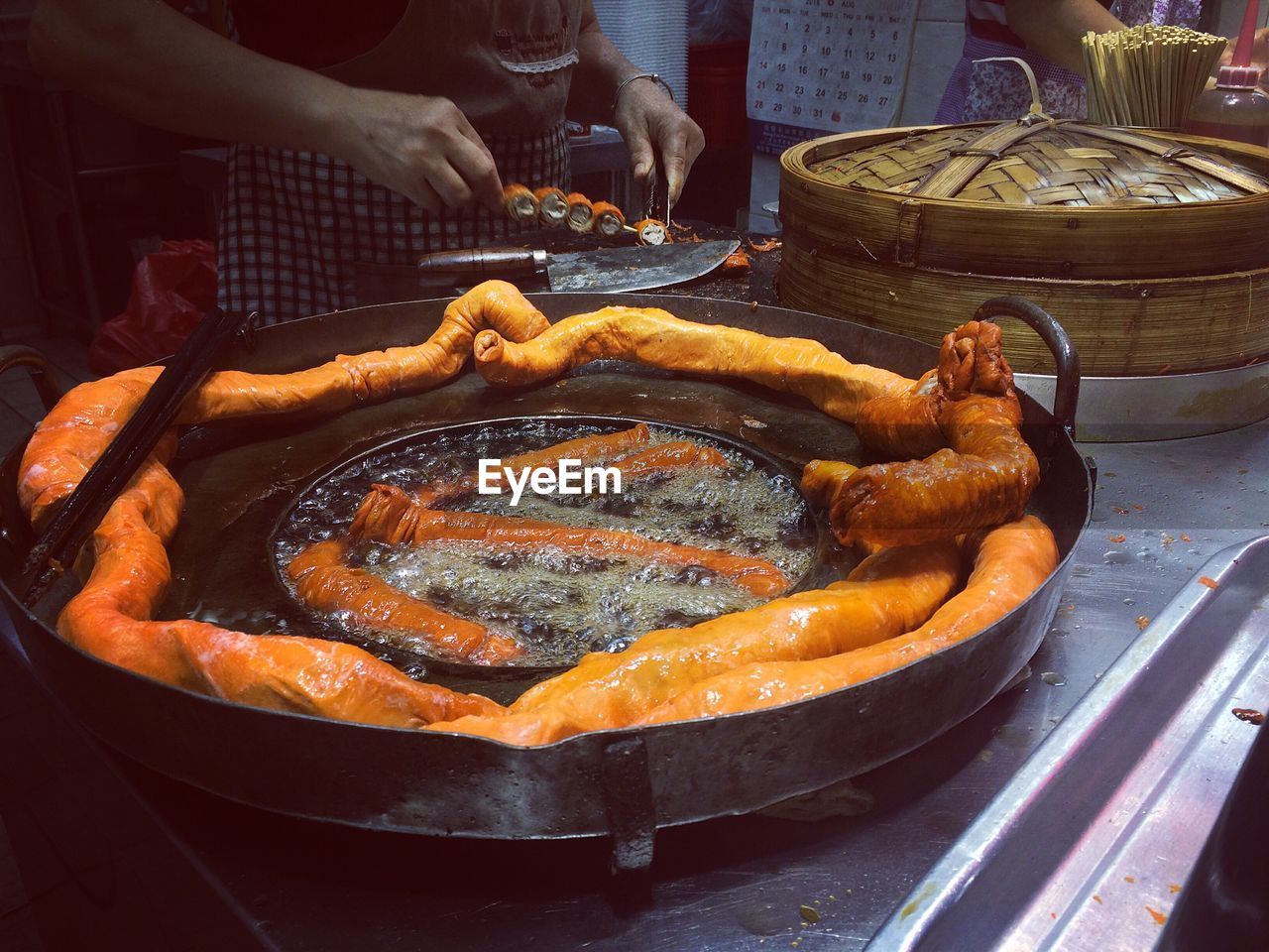 Midsection of man preparing food in kitchen