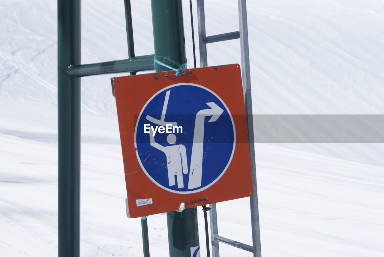 CLOSE-UP OF ROAD SIGN AGAINST BLUE BACKGROUND