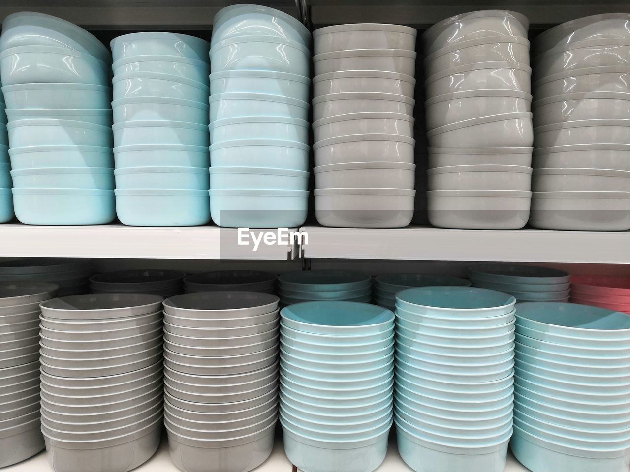 Full frame shot of stacked bowls on shelves in store