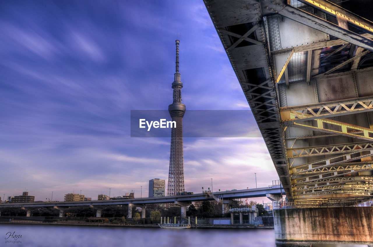 View of bridge over river against cloudy sky