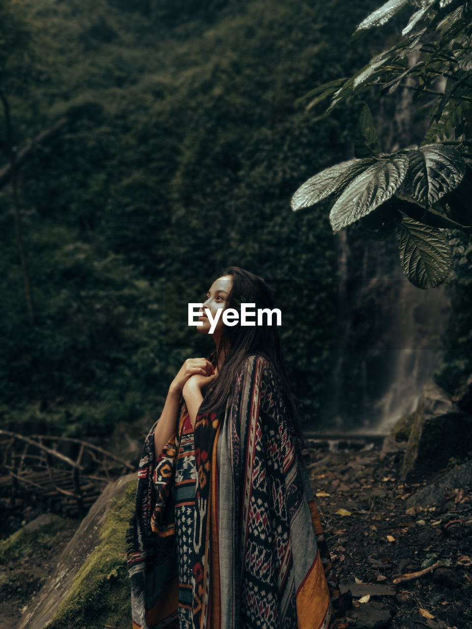 Young woman looking at camera in forest