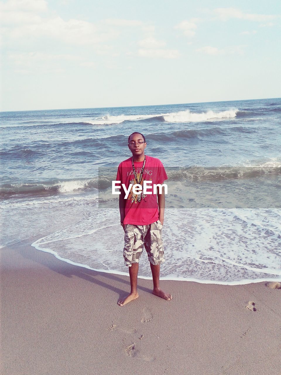 PORTRAIT OF MAN STANDING ON BEACH