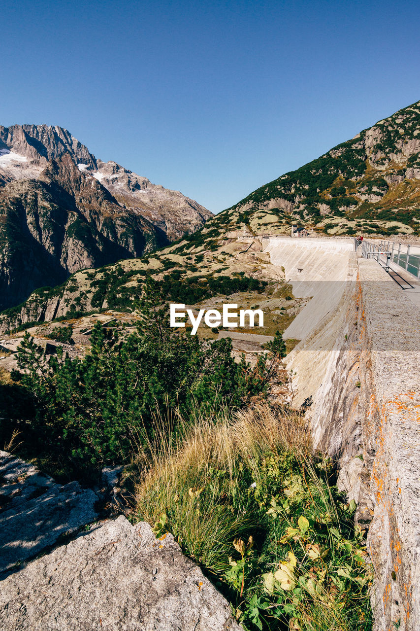 Scenic view of mountains against clear blue sky