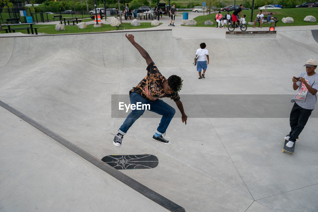 HIGH ANGLE VIEW OF CHILD SKATEBOARDING