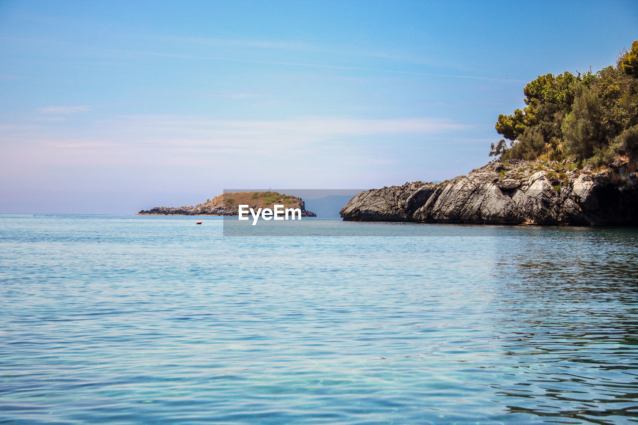 Scenic view of sea against blue sky