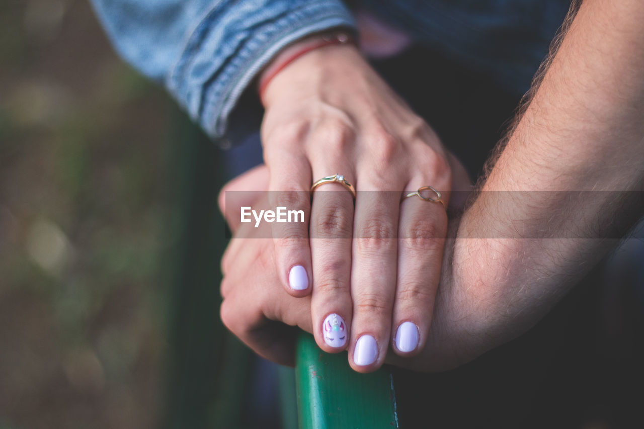 Cropped image of couple holding hands