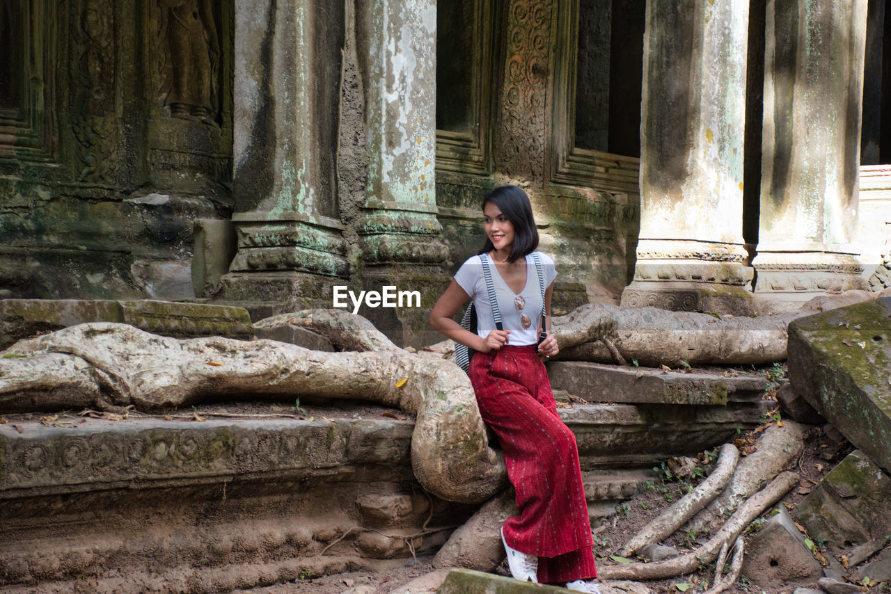 Thai girl is exploring the ancient ruins of angkor wat hindu temple complex in siem reap, cambodia