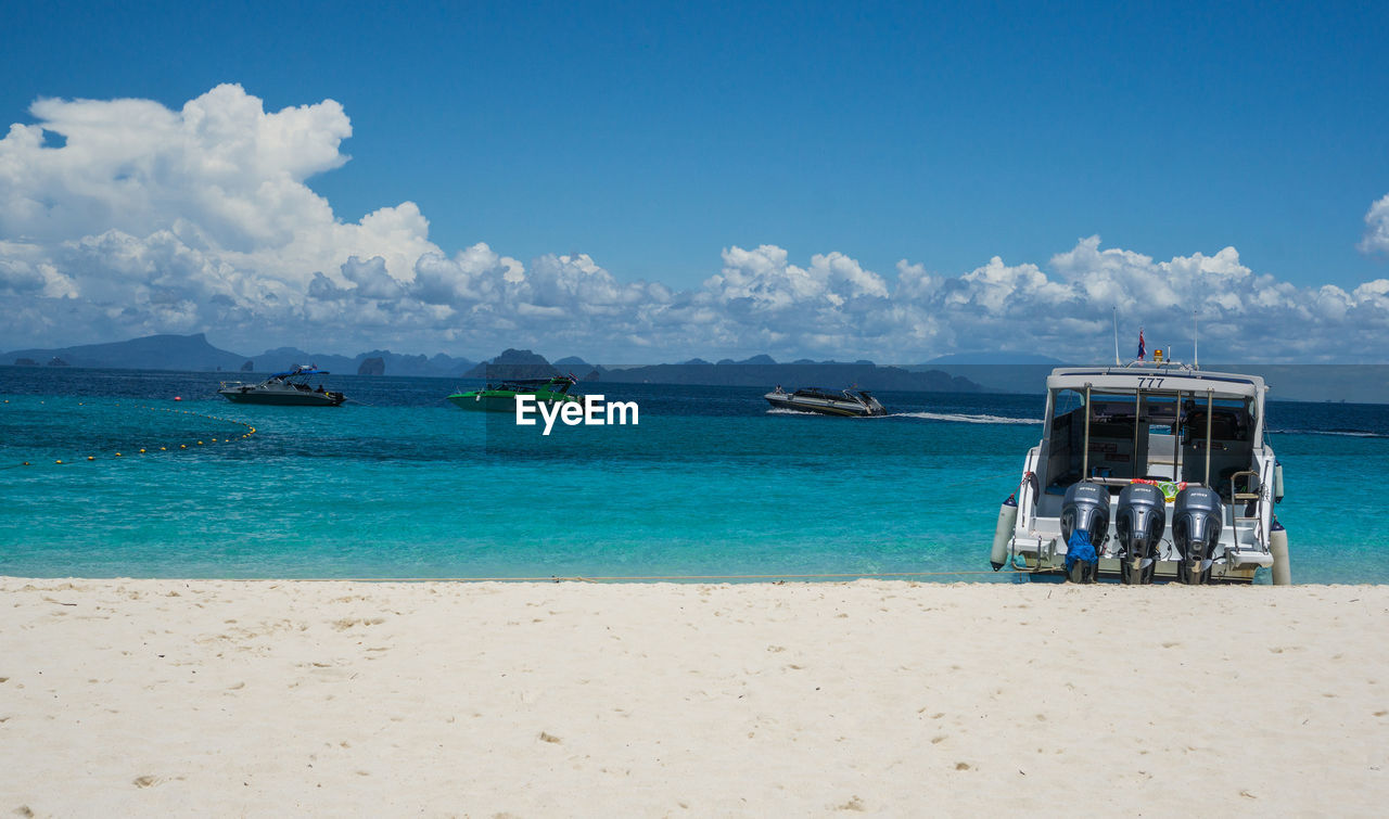 SCENIC VIEW OF BEACH AGAINST BLUE SKY