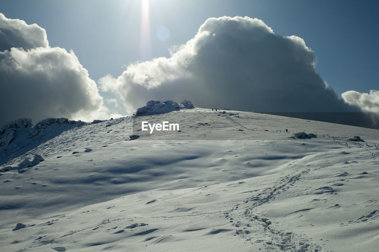 SNOW COVERED MOUNTAIN AGAINST SKY