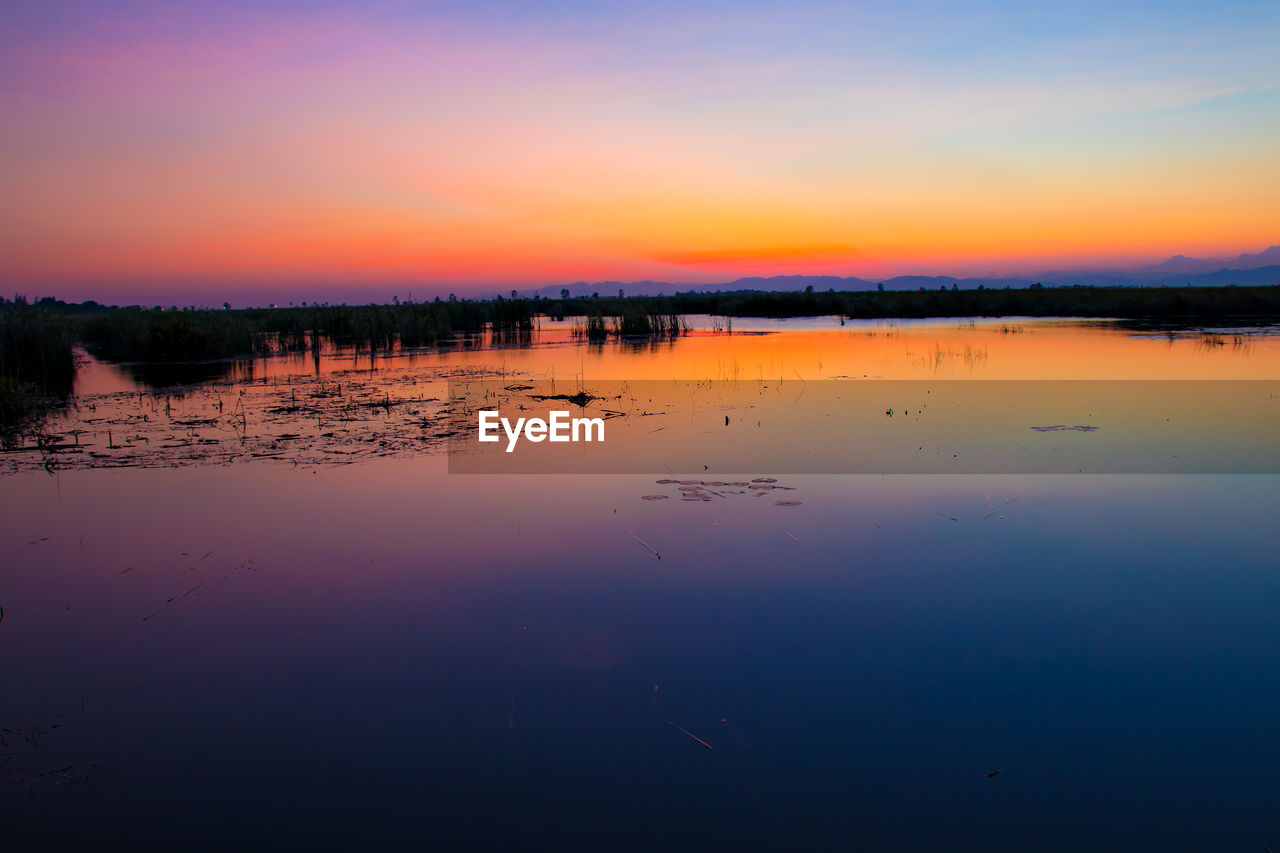 SCENIC VIEW OF LAKE DURING SUNSET