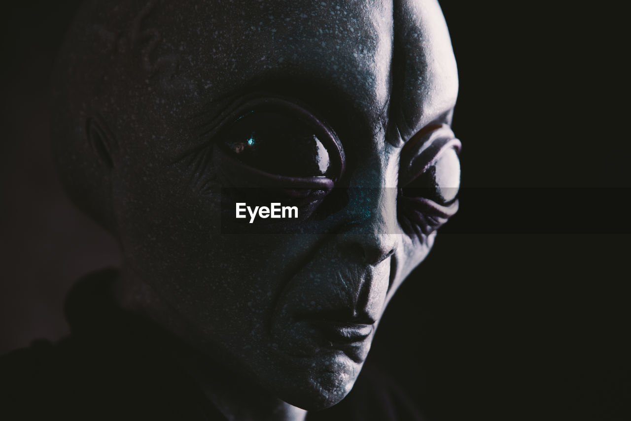 Close-up of alien against black background