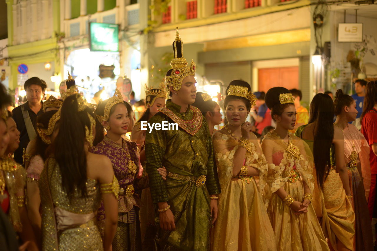 GROUP OF PEOPLE AT MARKET DURING FESTIVAL