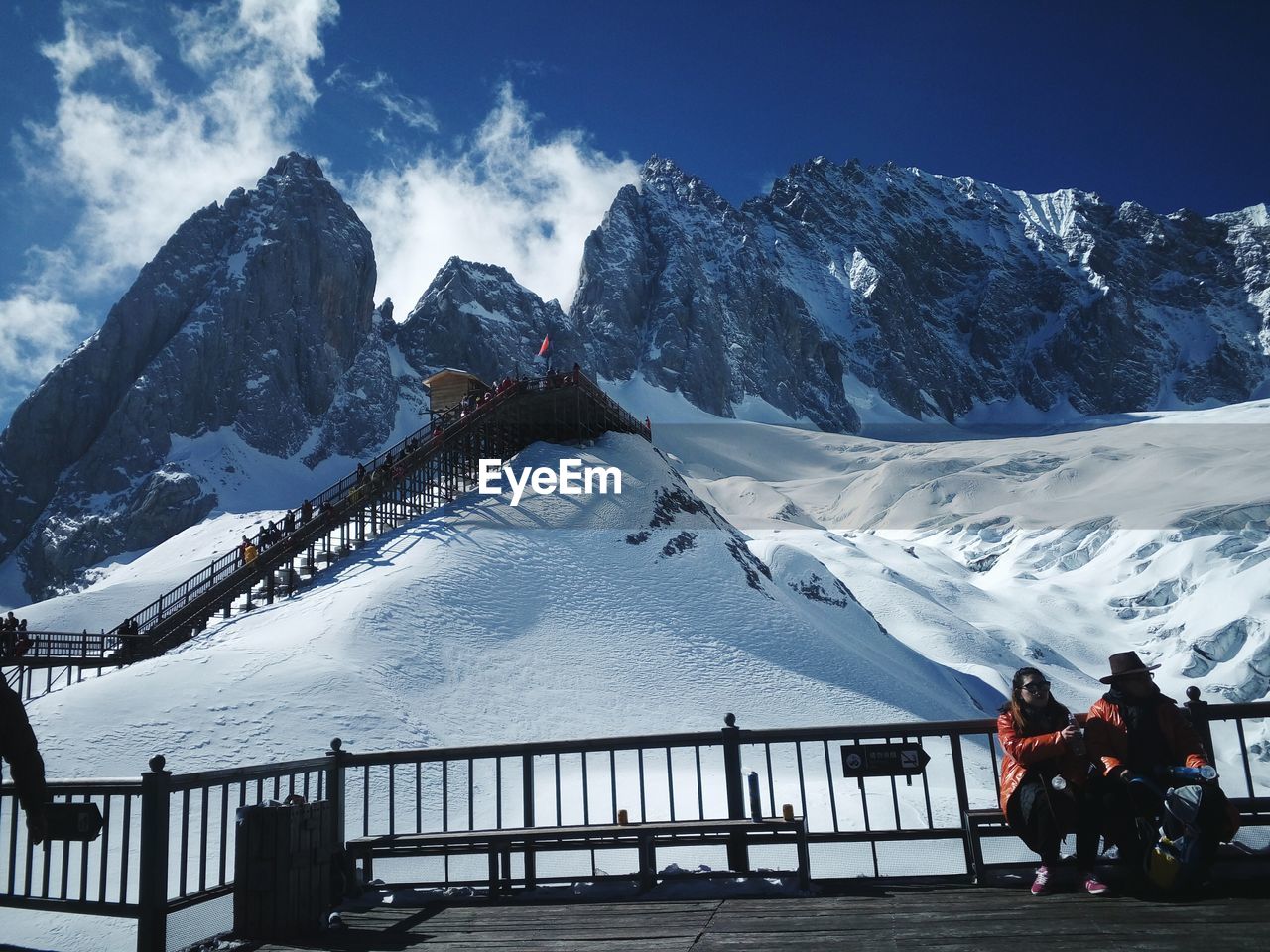 PANORAMIC VIEW OF PEOPLE ON SNOWCAPPED MOUNTAIN